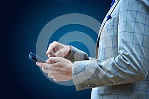 Businessman in suit using smartphone in hand