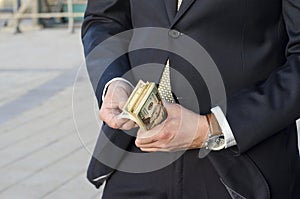 Businessman in a suit with a wad of cash. time to make money.