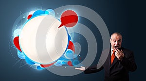 Businessman in suite holding a phone and presenting abstract modern speech bubble