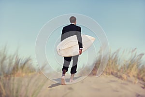 Businessman with Surfboard Going to the Beach