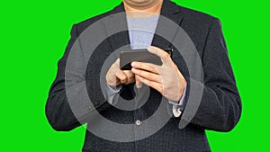 Businessman surfing the smartphone Alpha channel, keyed green screen.