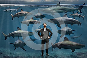 Businessman Surrounded By Sharks