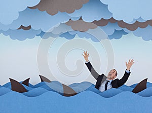 Businessman surrounded by sharks in stormy sea.