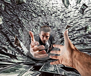 Businessman swallowed by a black hole of money needs help. Concept of failure and economic crisis. photo