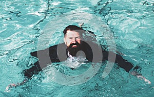 Businessman swimming in suit in the pool. Funny and crazy man in swimming Pool. Business Man having fun by the Pool.