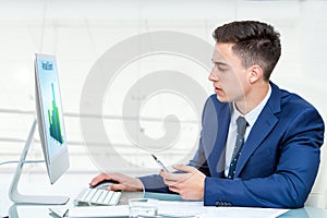 Businessman synchronizing smart phone with computer