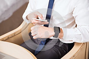 Businessman syncing smart watch to his phone