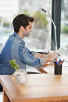 Businessman, tablet and desk working online for research, networking and planning in office. Male person, reading and