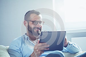 Businessman with tablet and earphones