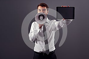 Businessman with tablet pc and megaphone