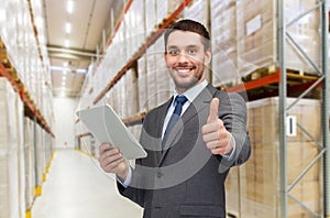 Businessman with tablet pc over warehouse