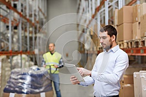 Businessman with tablet pc at warehouse