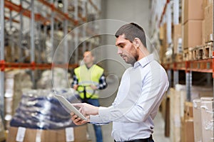 Businessman with tablet pc at warehouse