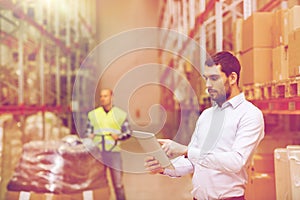 Businessman with tablet pc at warehouse