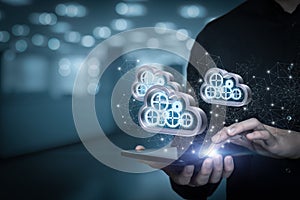 Businessman on tablet work with computing data clouds