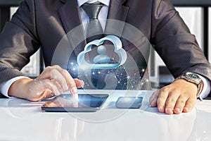 Businessman on a tablet working with data cloud