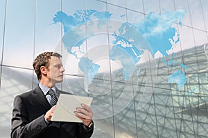 Businessman with tablet world map cloud computing global concept
