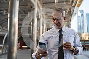 businessman take off glasses and text on phone photo