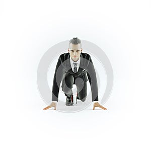 Businessman taking low start to running. On white background.