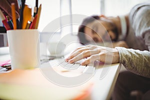 Businessman taking nap in office