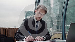 Businessman taking notes or signing contract, pen and document, man in formal jacket. Close up hand