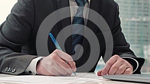 Businessman taking notes or signing contract, pen and document, man in formal jacket. Close up hand