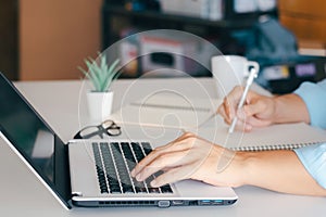 Businessman taking notes Summarize the meeting online with laptop.