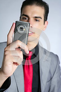 Businessman taking photos with phone camera