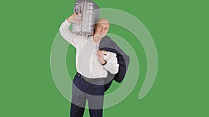 Businessman taking to shoulders travel suitcase on green background. Tourist man holding suitcase and jacket on