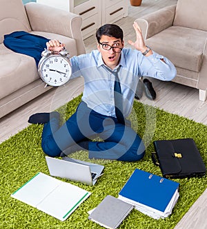 Businessman taking work home and working overtime