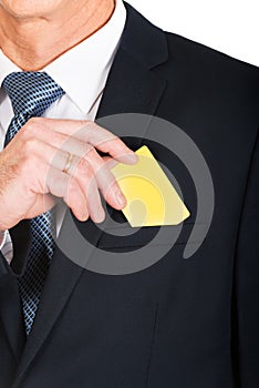 Businessman taking a yellow card from pocket