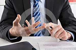 Businessman talking with hands about ruls and regulations. photo