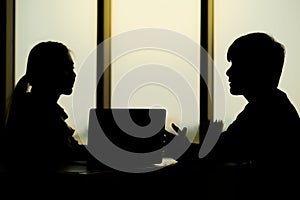 Businessman is talking with his collegue in the evening time in the modern office photo