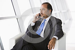 Businessman talking on mobile phone in lobby