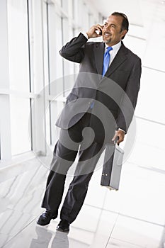 Businessman talking on mobile phone in lobby