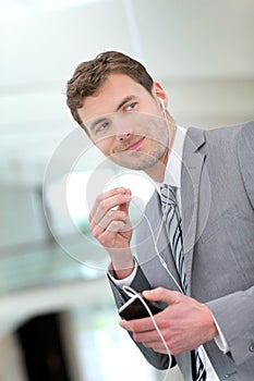 Businessman talking on the phone with earphones