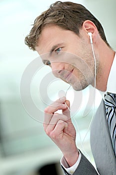 Businessman talking on phone with earphones