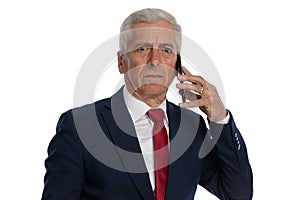 Businessman talking on the phone and feeling insulted