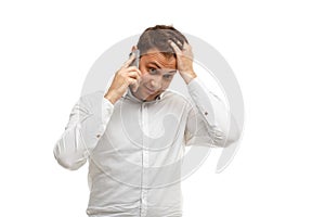 Businessman talking phone holding head