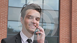 Businessman Talking on Phone Outside Office