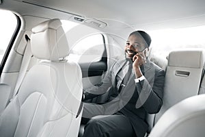 Businessman Talking On Phone Sitting In Car During Business Trip