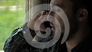 Businessman talking on the phone in a train.