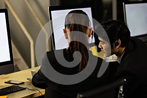 Businessman talking with team and working overtime late at night in call center office