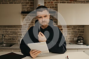 A businessman talking to his colleagues about a business by a video conference