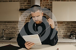 A businessman talking to his colleagues about a business by a video conference