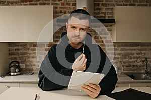 A businessman talking to his colleagues about a business by a video conference