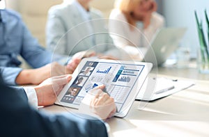 Businessman talking to his colleagues in video conference. Business team working from office using digital tablet