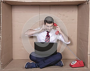 Businessman talking on two telephones at once