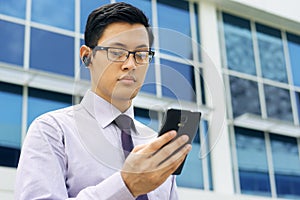 Businessman Talking Video Call On Mobile With Bluetooth Headset photo