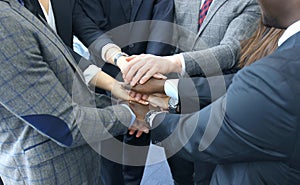 Businessman team in suit touching hands together. Selective focus.